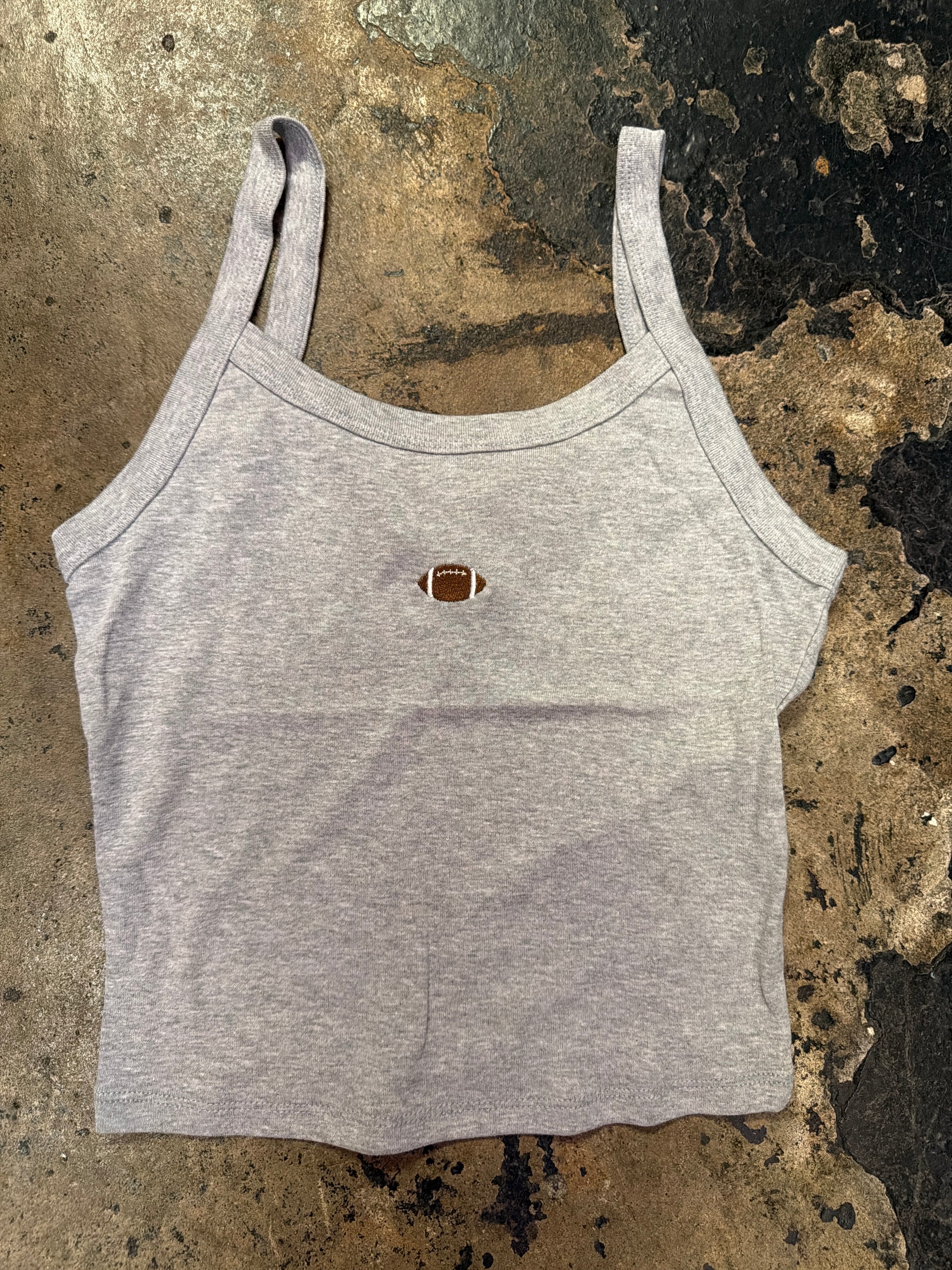 Gray cropped tank top with small embroidered football graphic at center chest