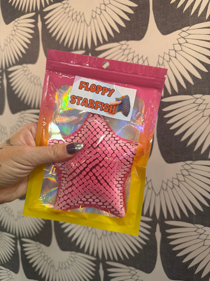 Pink chainmail star-shaped floppy fidget toy in holographic packaging by Pye Games