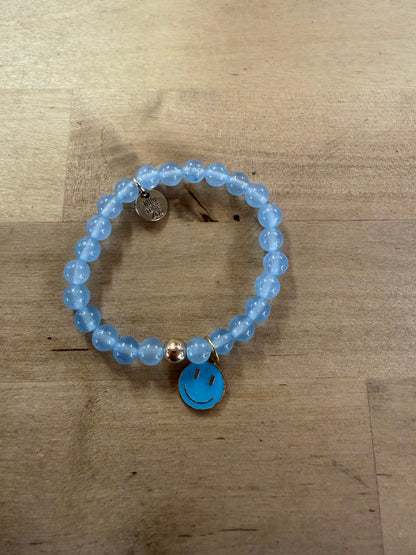Light blue beaded stretch bracelet with a turquoise enamel smiley face charm