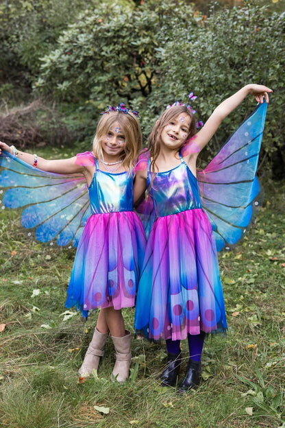 Two girls wearing blue and purple butterfly fairy dresses with wings and headbands