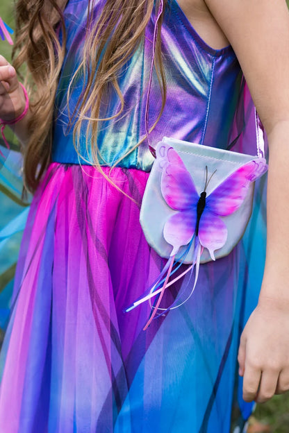 Girl wearing iridescent blue-purple fairy dress with butterfly crossbody purse accessory