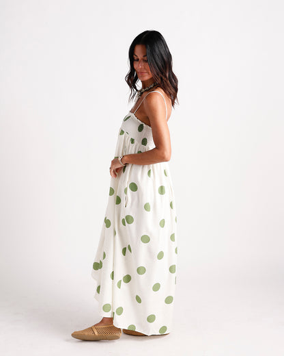 White maxi dress with green polka dots, smocked bodice, spaghetti straps, flowy skirt