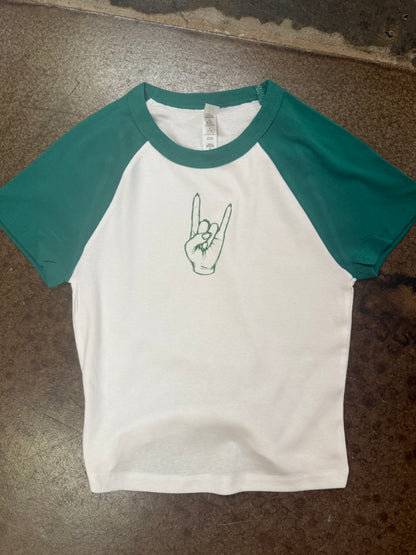 White raglan baby tee with teal sleeves and green rock hand graphic