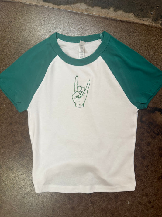 White raglan baby tee with teal sleeves and green rock hand graphic