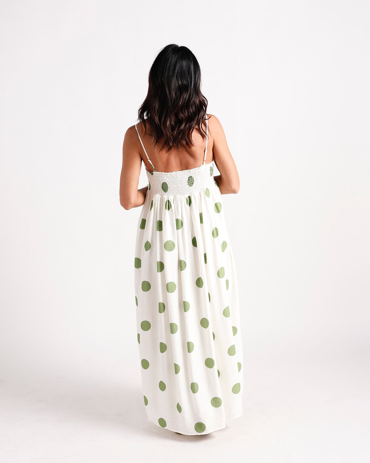 White maxi dress with green polka dots, smocked back, spaghetti straps, full skirt