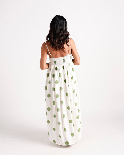 White maxi dress with green polka dots, smocked back, spaghetti straps, full skirt