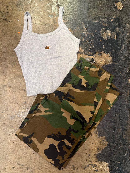 Gray sleeveless tank top with small football embroidery, styled with camo pants