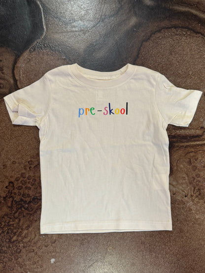 White kids' tee with colorful 'pre-skool' text on chest