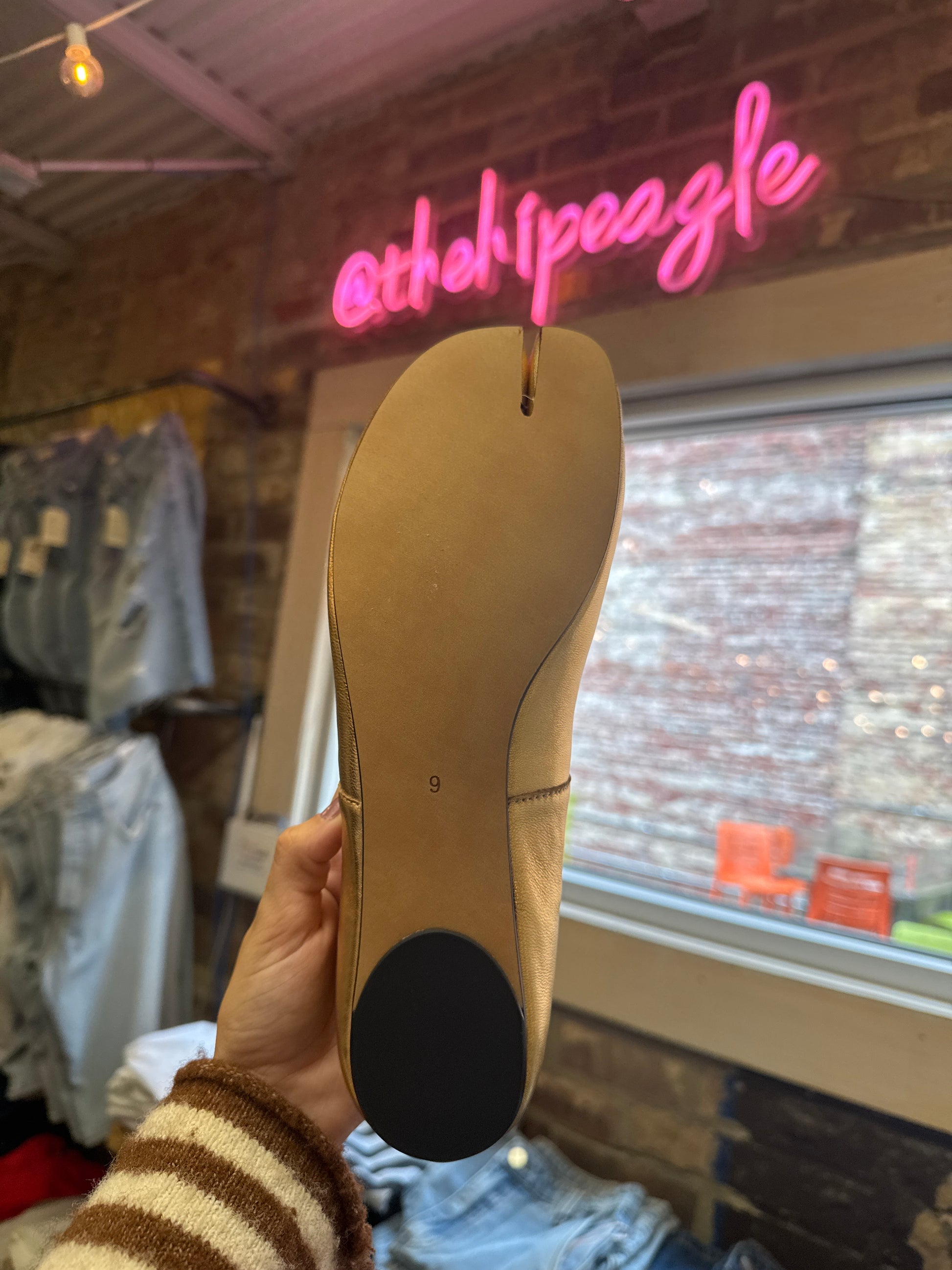 Gold ballet flat sole view, size 9, with black heel cap