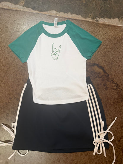 White and teal raglan baby tee with green rock hand graphic on chest