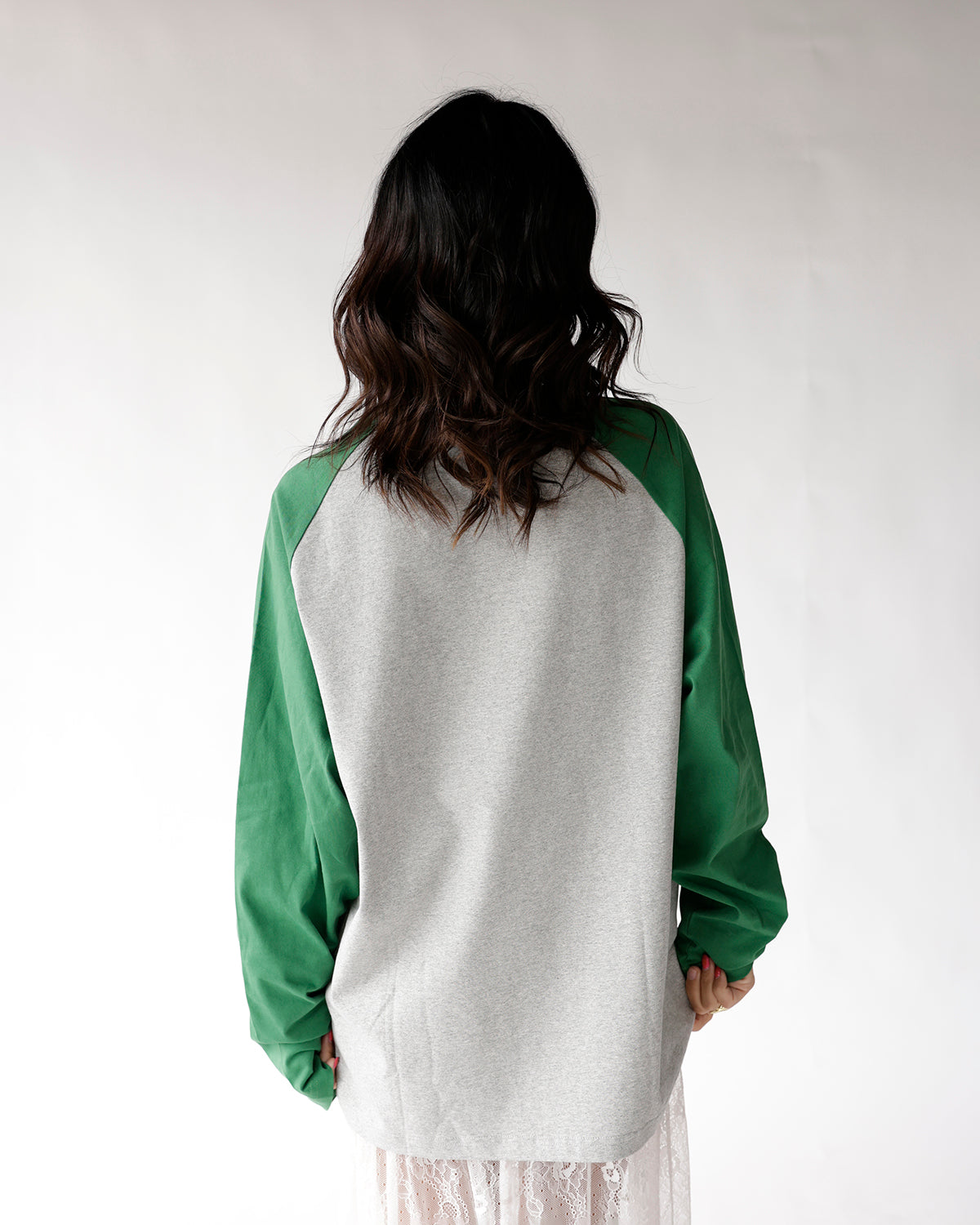 Gray and green raglan long sleeve tee, back view, worn by model