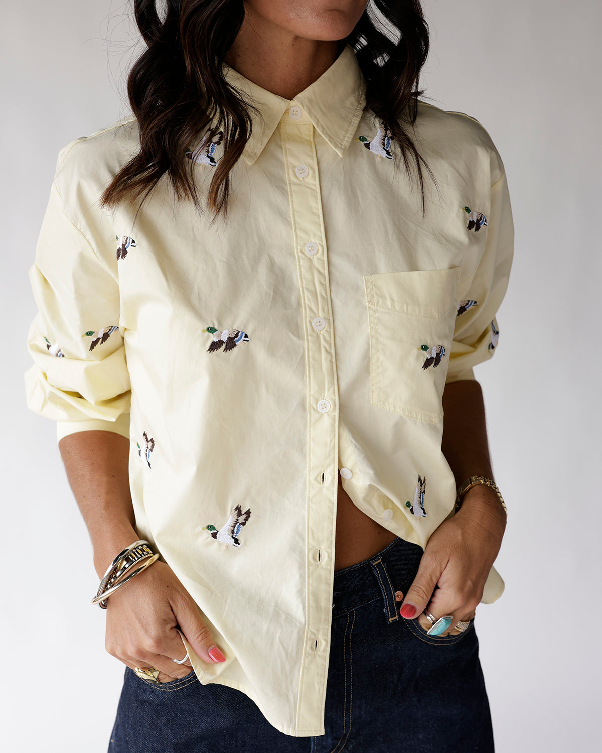 Light yellow button-up shirt with embroidered flying mallard duck pattern and chest pocket