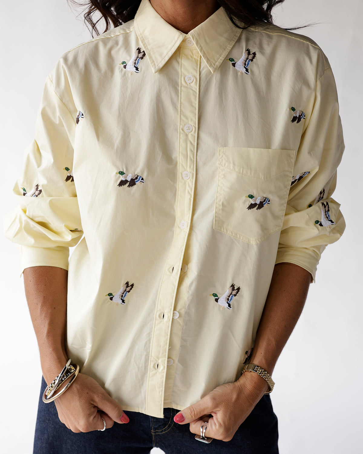 Light yellow button-up shirt with embroidered flying mallard duck pattern, chest pocket