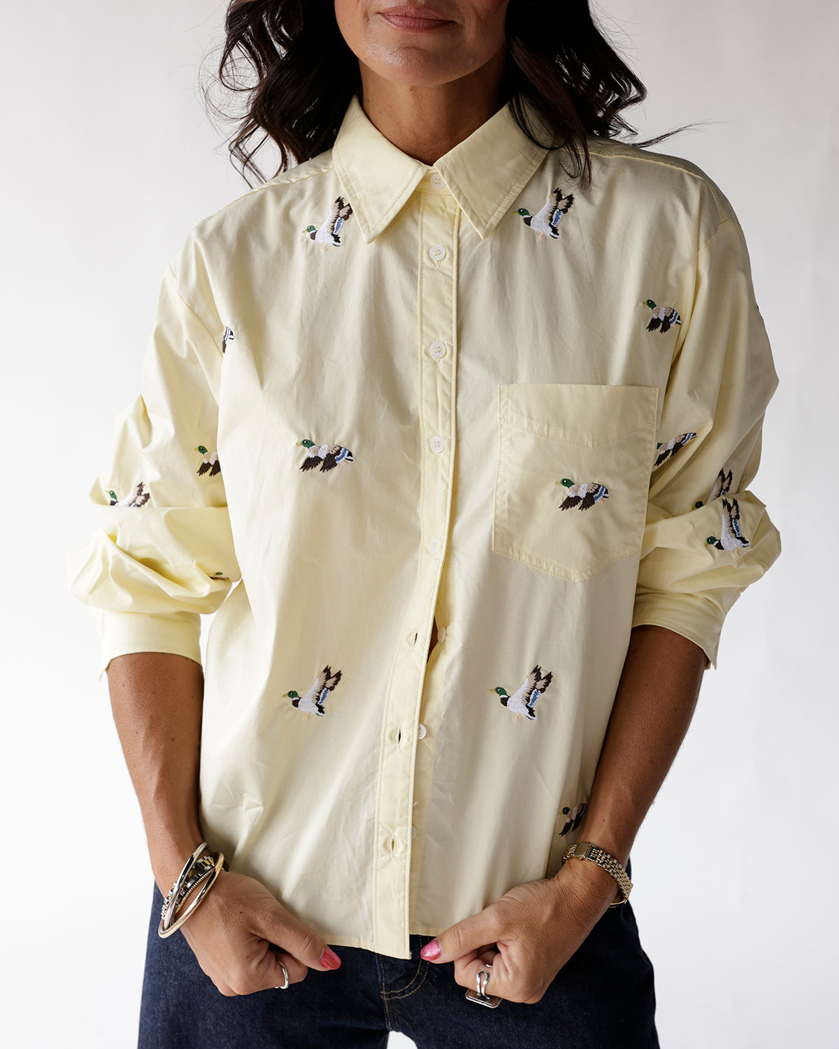Pale yellow button-up shirt with embroidered flying mallard duck pattern, chest pocket