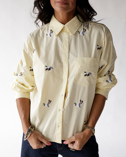 Pale yellow button-up shirt with embroidered flying mallard duck pattern, chest pocket