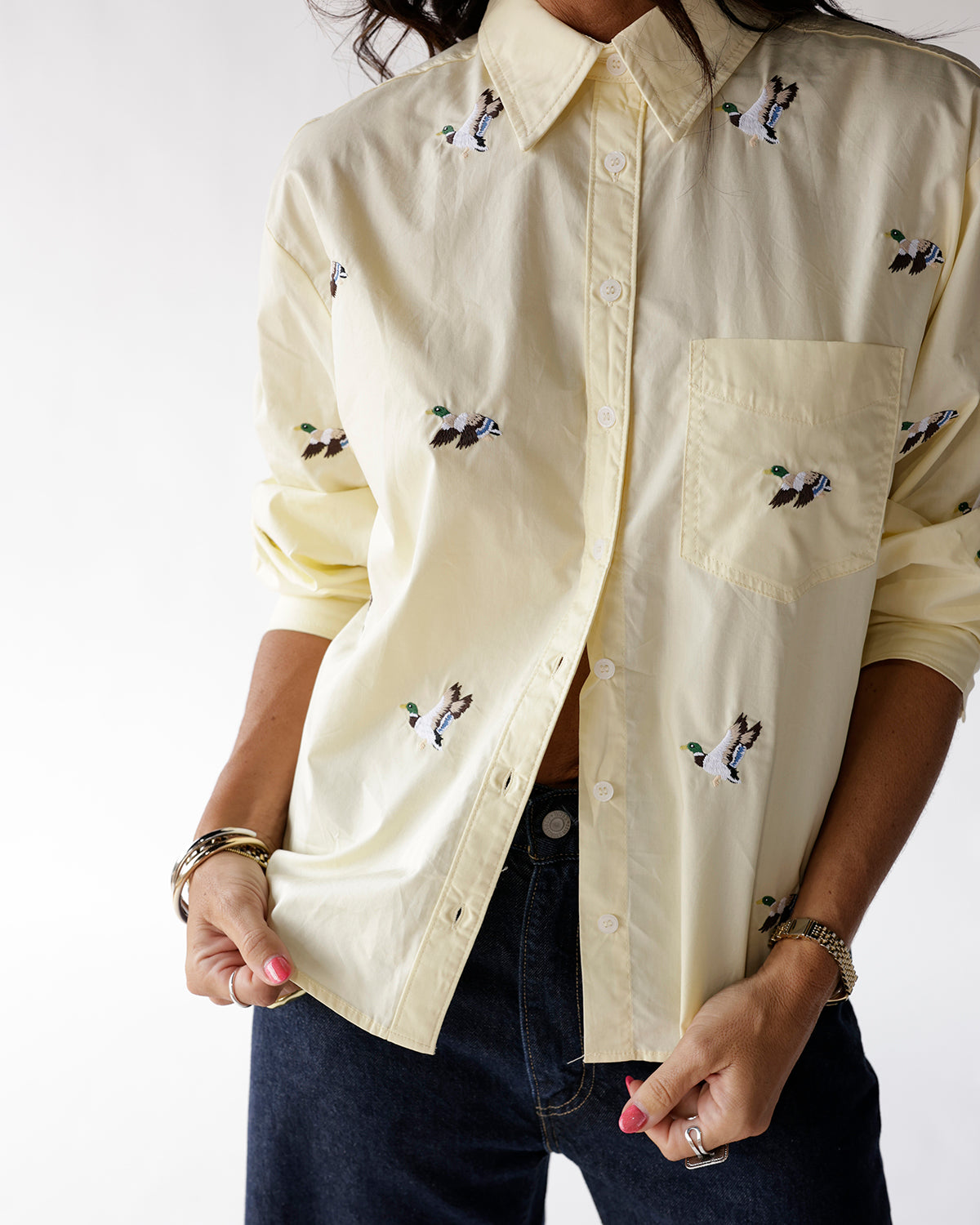Light yellow button-up shirt with embroidered flying mallard duck pattern and chest pocket