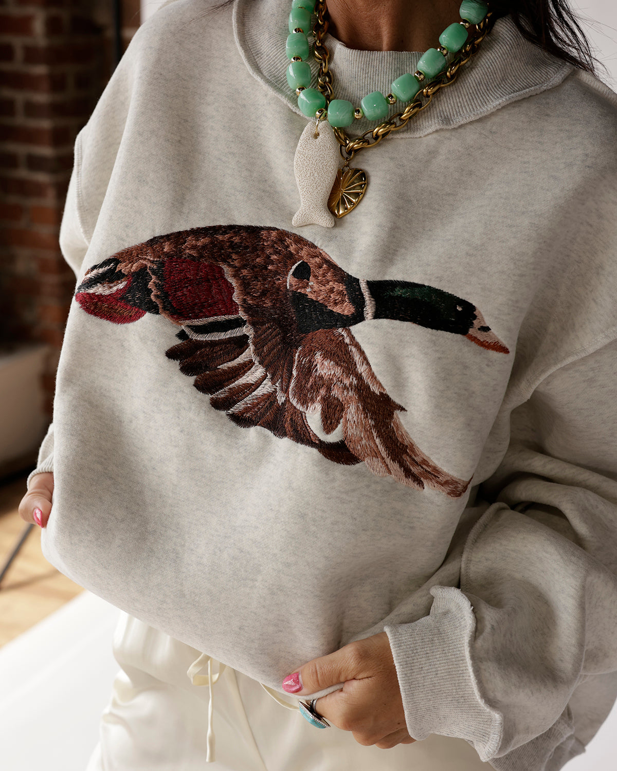 Heather gray mock neck sweatshirt with large mallard duck embroidery on chest