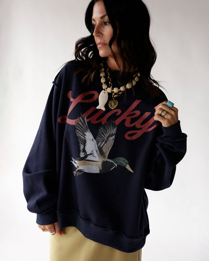 Oversized navy sweatshirt with Lucky script and mallard duck graphic print