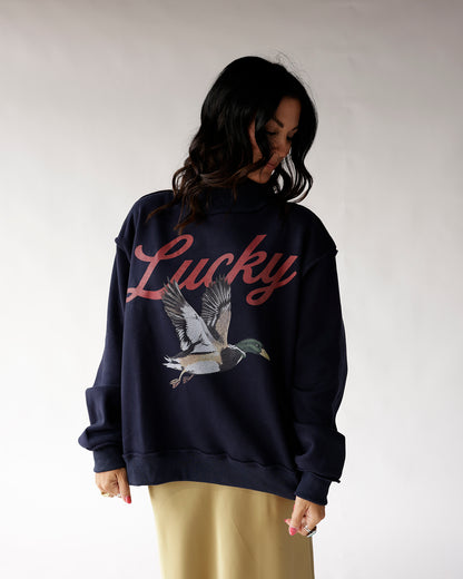 Navy blue mock neck sweatshirt with Lucky script and mallard duck graphic