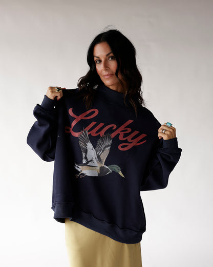 Navy oversized mock neck sweatshirt with mallard duck graphic and Lucky script print