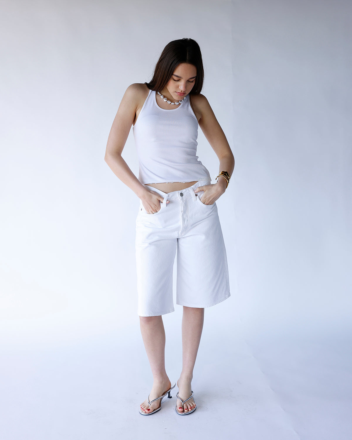 AGOLDE Ramona wide-leg white denim shorts, knee-length, worn with white crop top