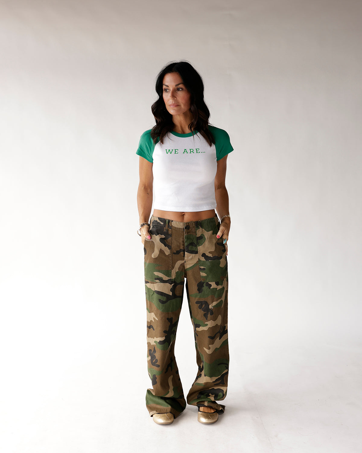 White and green raglan baby tee with 'WE ARE...' text, cropped fit