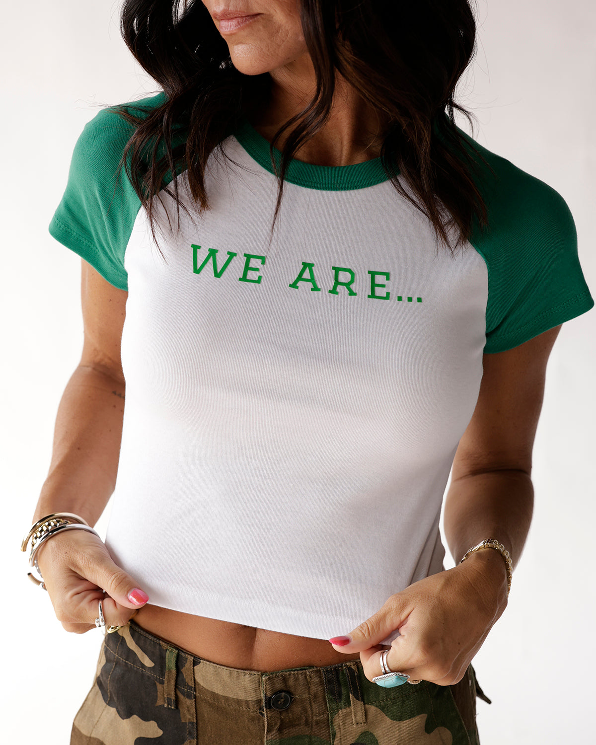 White and green raglan baby tee with WE ARE... graphic on chest