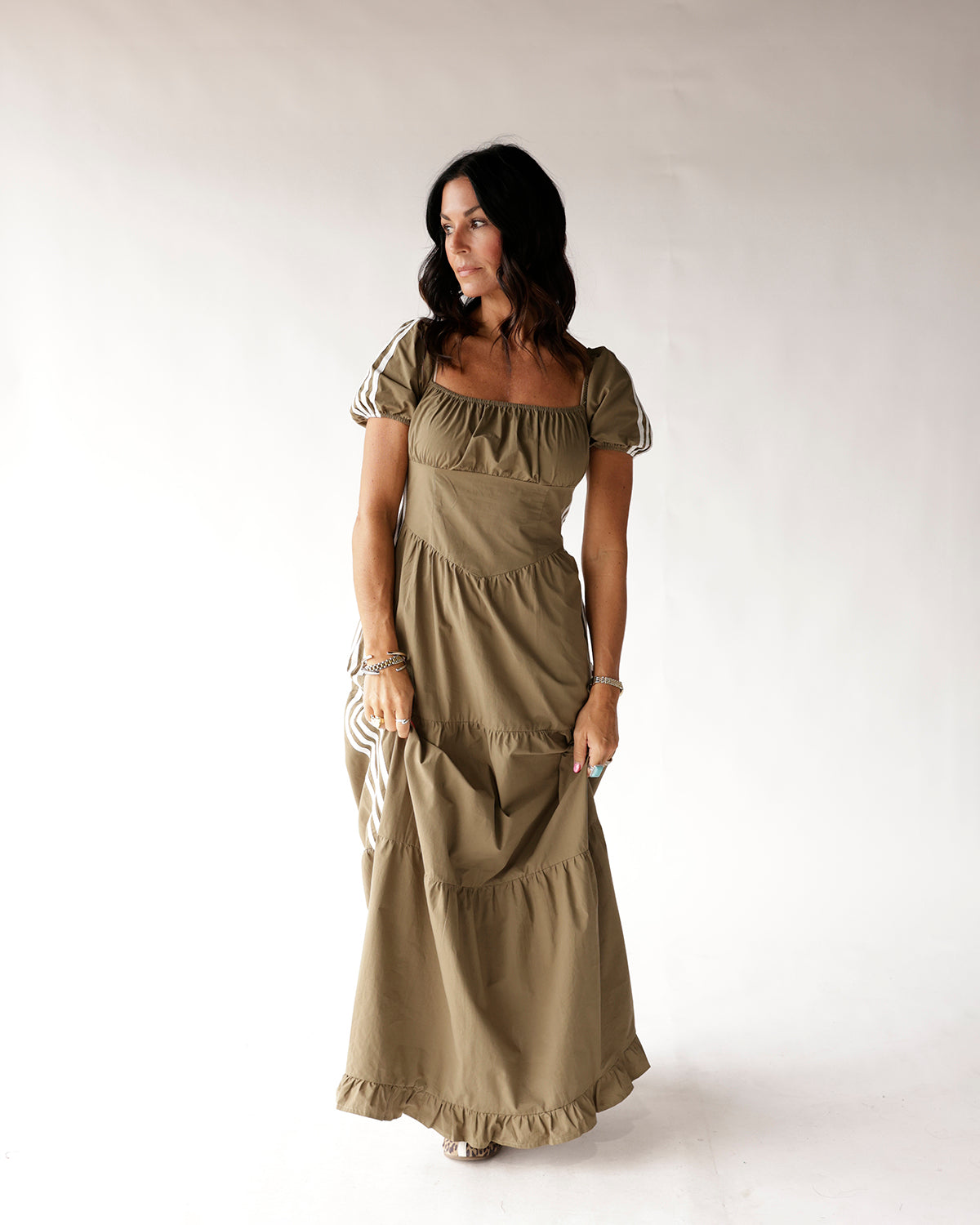 Olive green tiered maxi dress with puff sleeves and striped trim detail