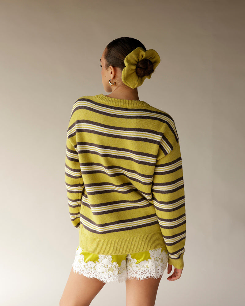 Yellow and brown striped knit sweater with ribbed hem, back view