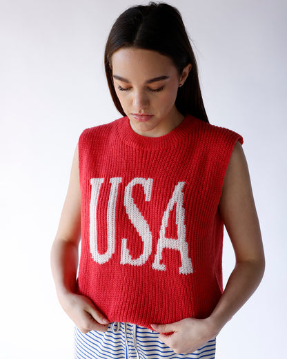 Red chunky knit sleeveless sweater vest with white USA lettering on front