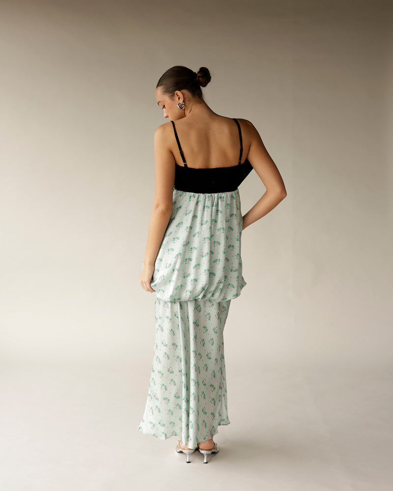 White floral maxi dress with black spaghetti strap bodice, worn with silver heels