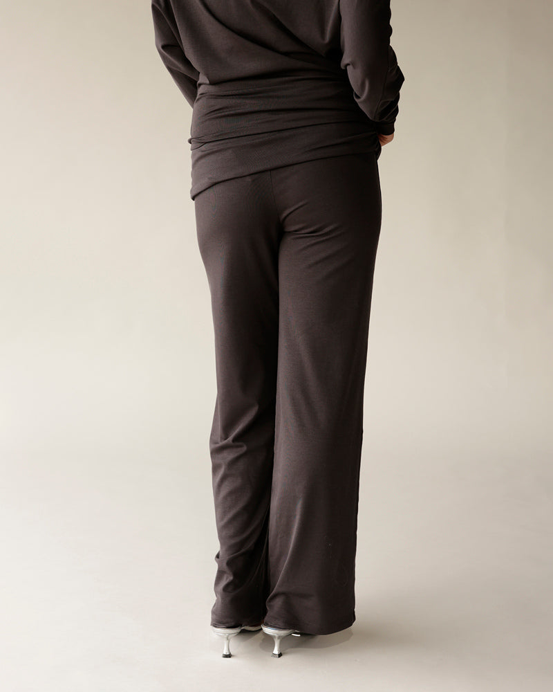 Dark brown wide-leg knit pants with fold-over waistband, back view