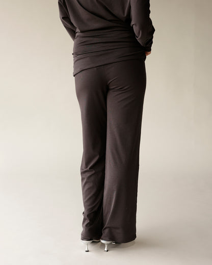 Dark brown wide-leg knit pants with fold-over waistband, back view