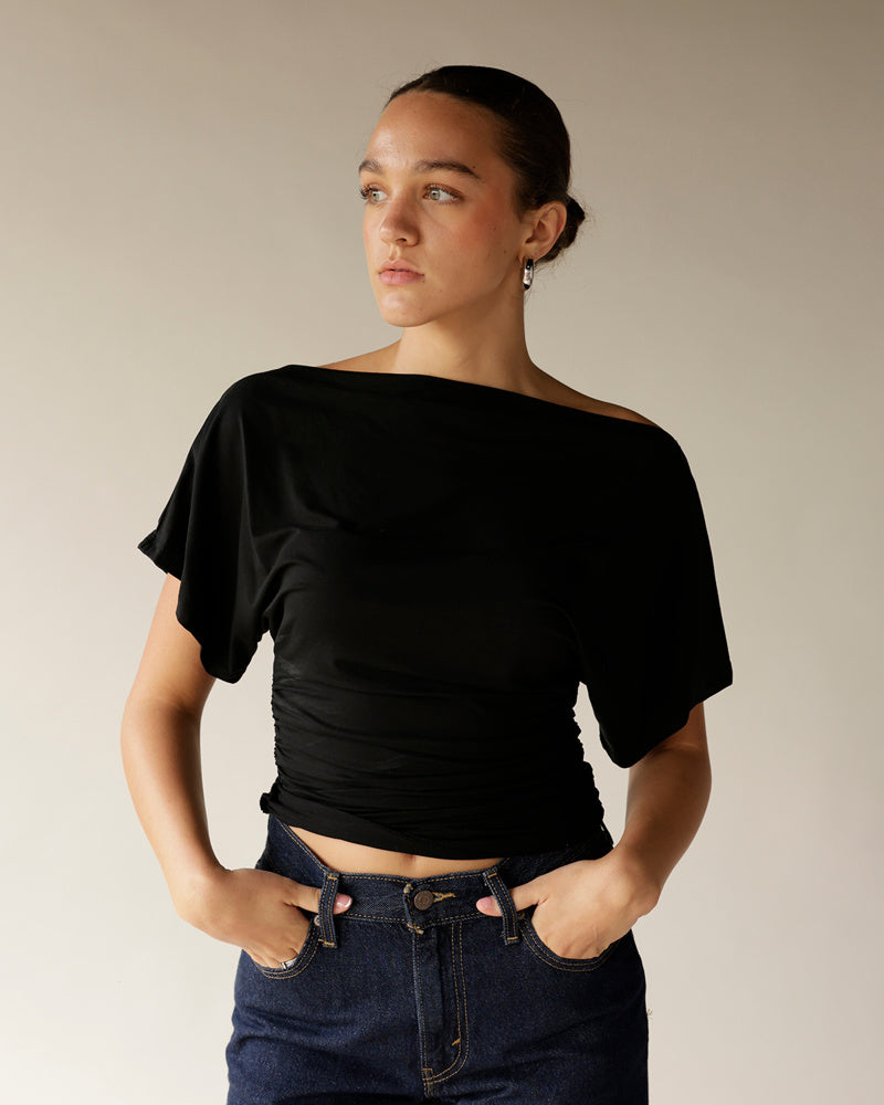 Dark navy high-rise straight-leg denim pants worn with black off-shoulder top