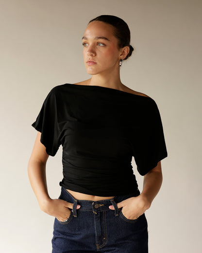 Dark navy high-rise straight-leg denim pants worn with black off-shoulder top
