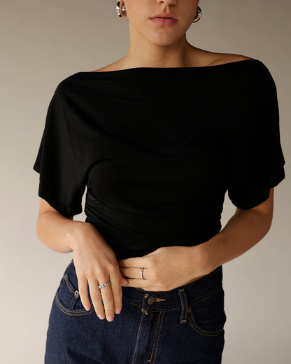 Dark wash high-waist straight-leg jeans paired with black off-shoulder crop top