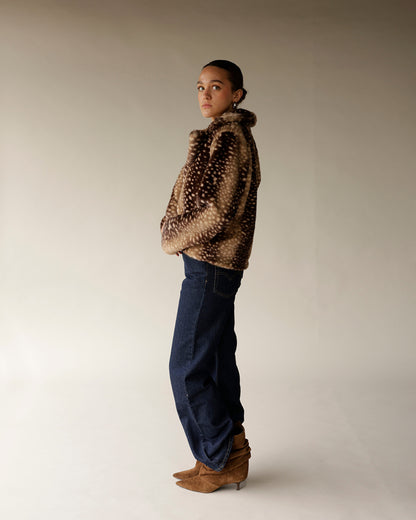 Women's cropped faux fur jacket in tan and brown spotted print with dark jeans