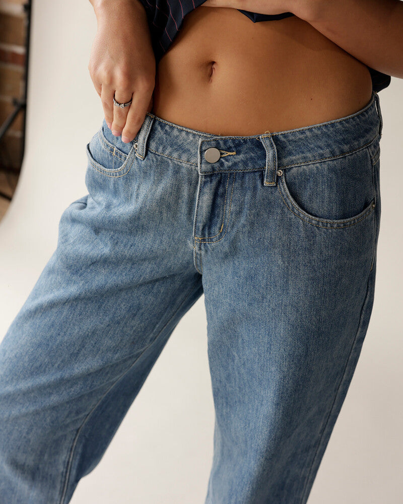 Women's low-rise wide-leg medium wash blue denim jeans with silver button closure
