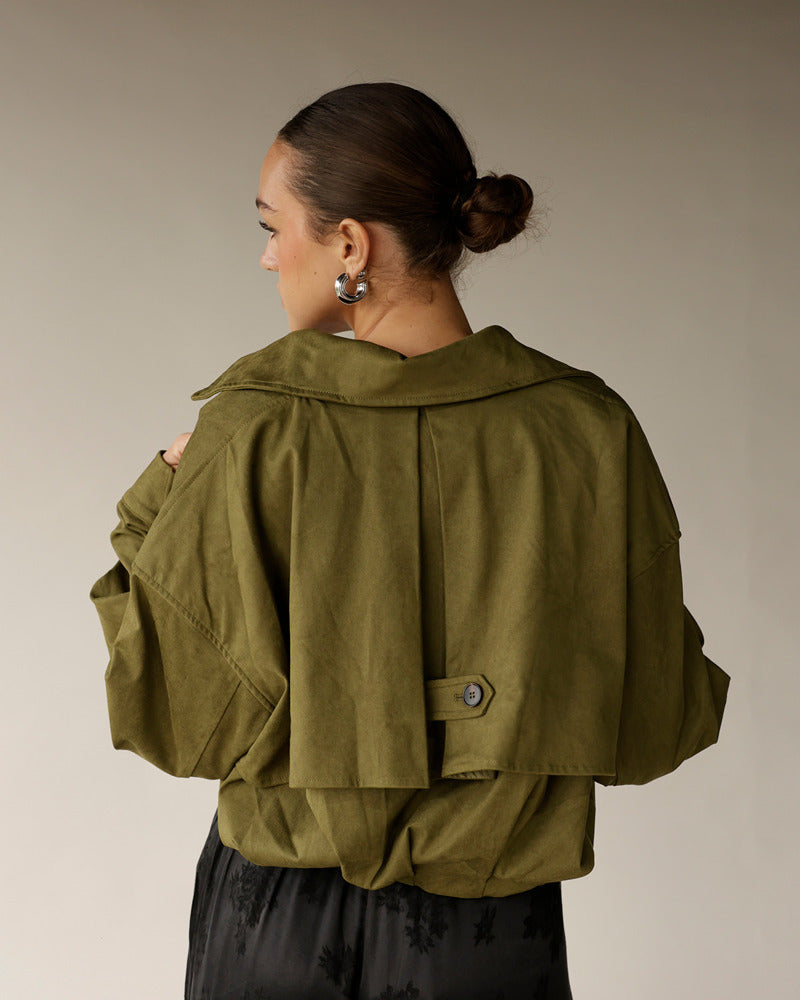 Women's olive green cropped trench jacket with back button tab detail
