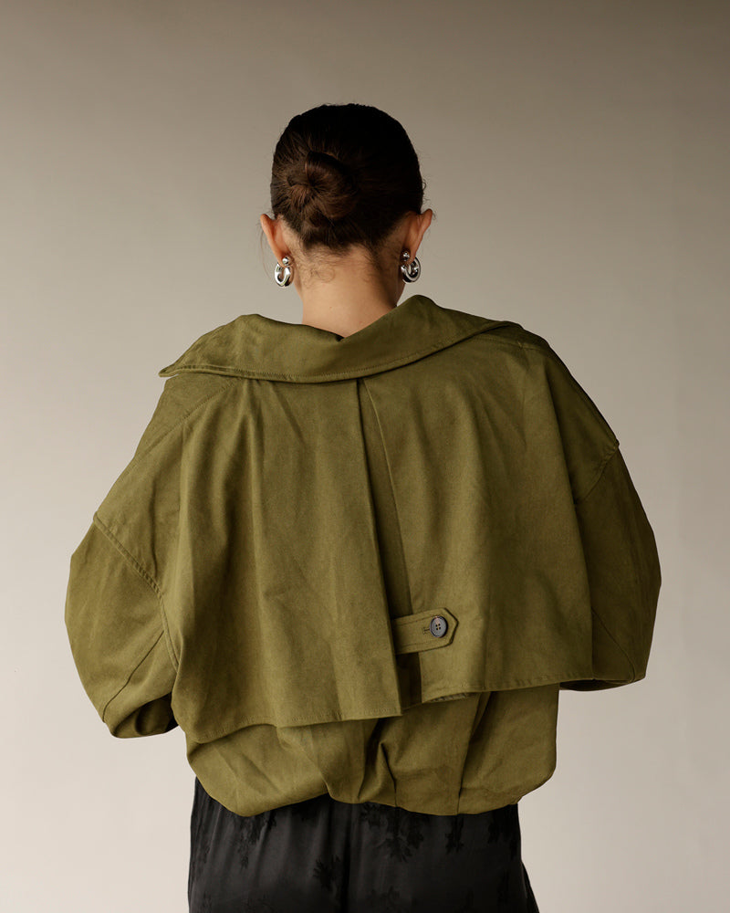 Women's olive green cropped jacket with wide collar, balloon sleeves, and back button detail