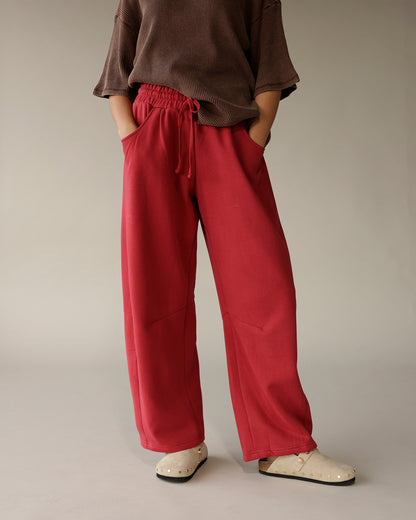 Brown ribbed short-sleeve tee styled with red wide-leg drawstring pants and cream clogs