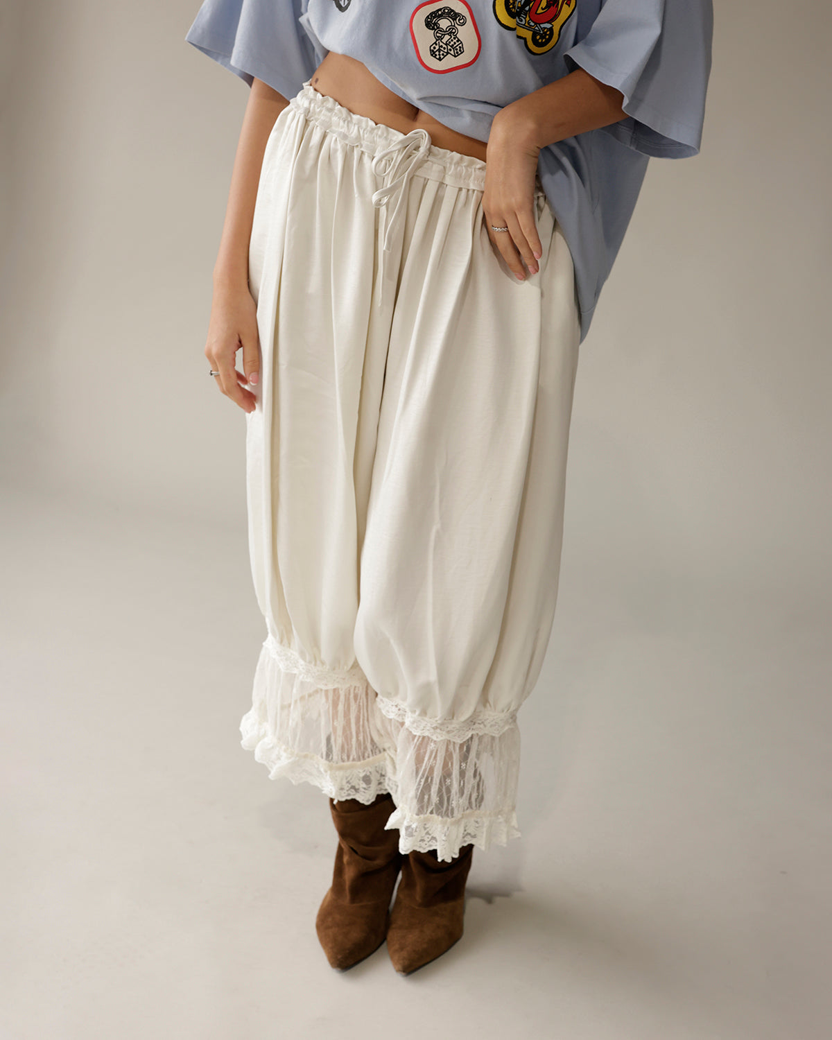 Cream satin balloon pants with white lace trim hem and drawstring waist