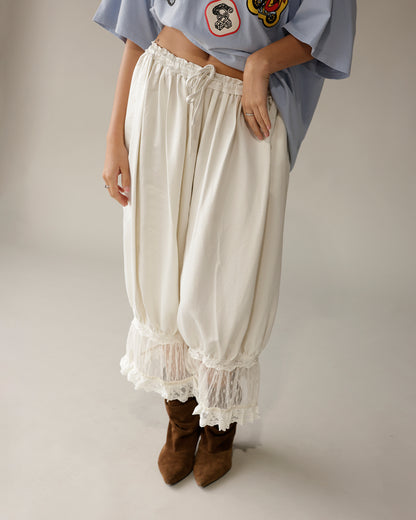 Cream satin balloon pants with white lace trim hem and drawstring waist