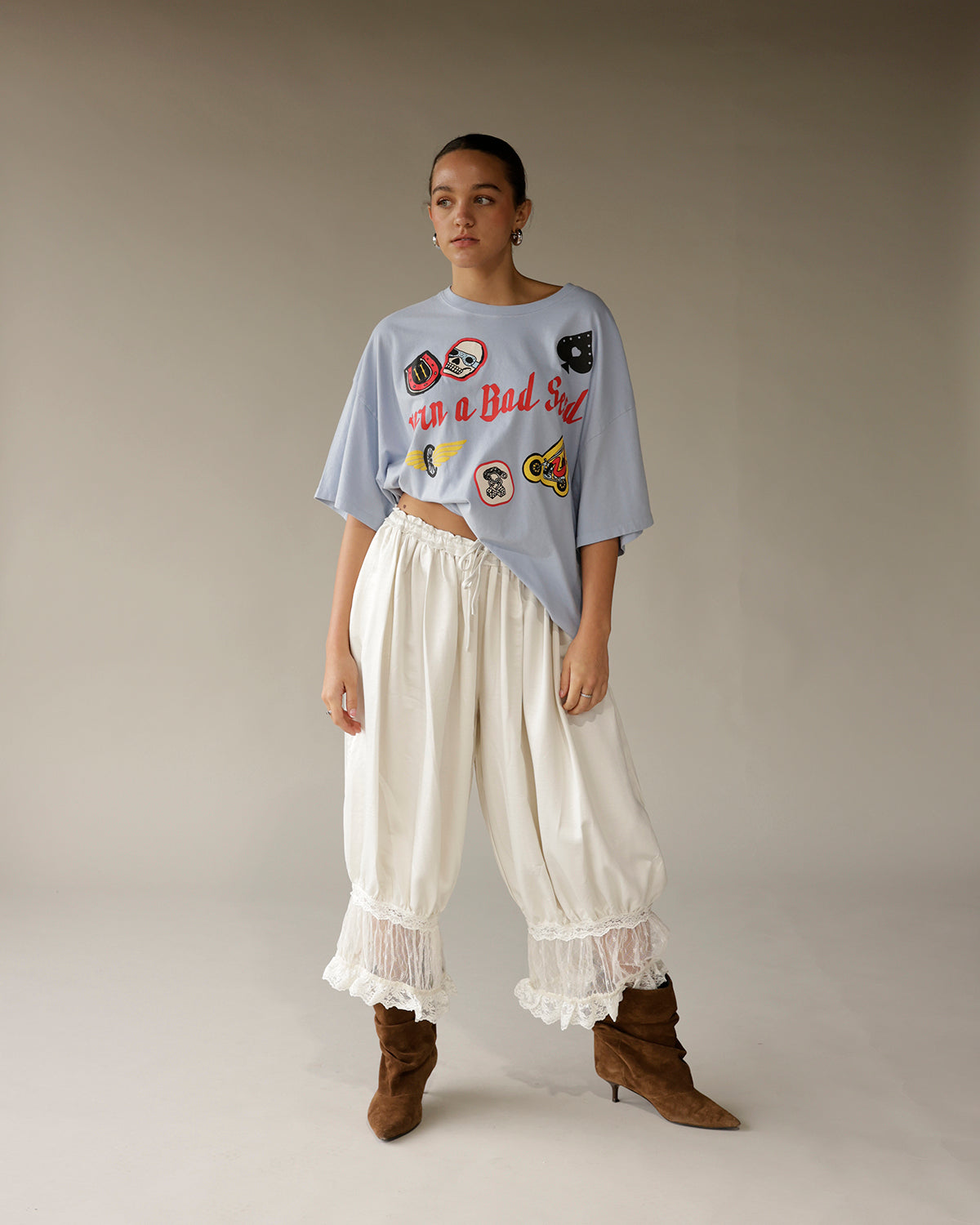 Ivory wide-leg satin pants with lace trim hem and gathered ankles by MIMOSA