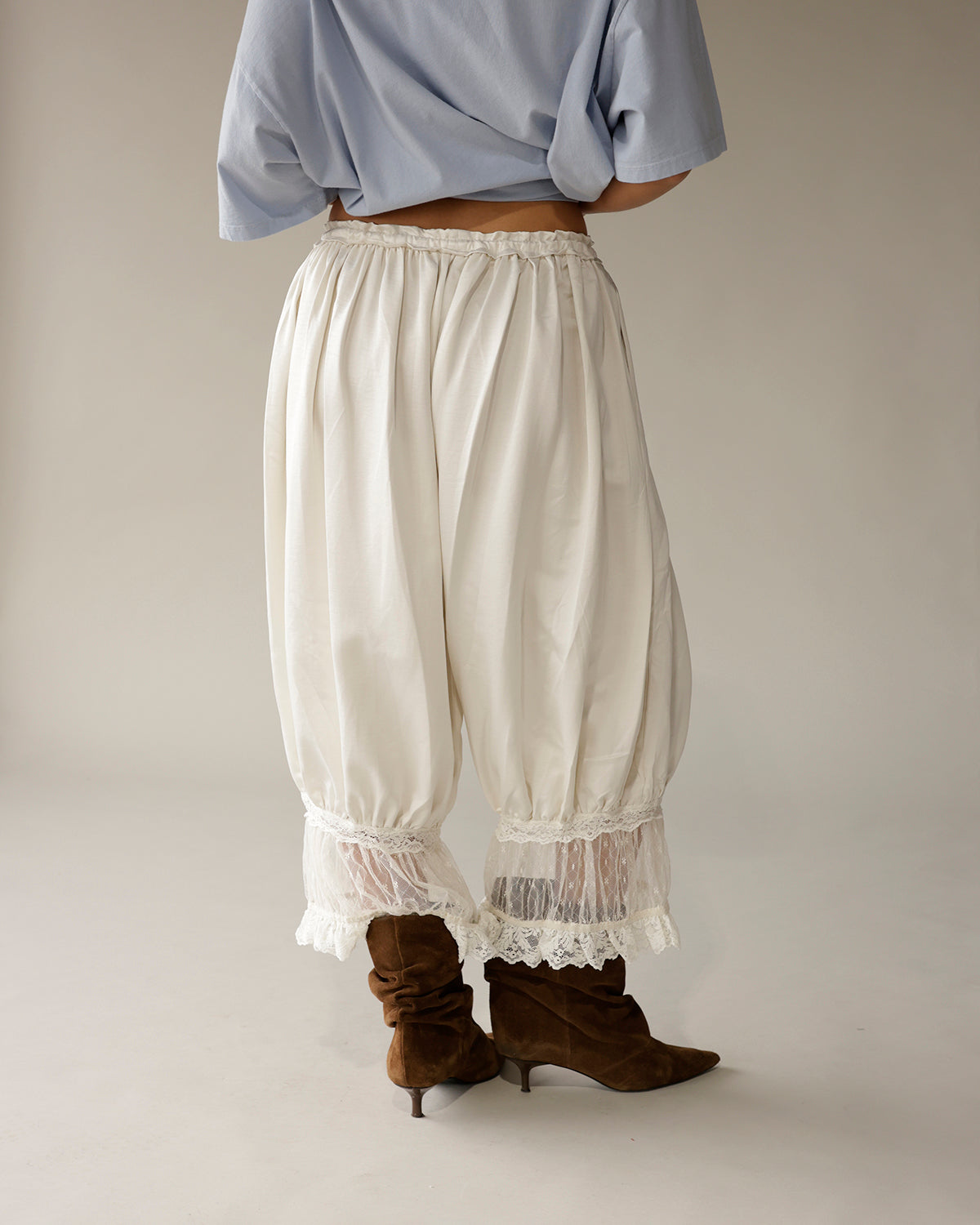 Ivory boho balloon pants with lace trim hem, paired with brown suede boots