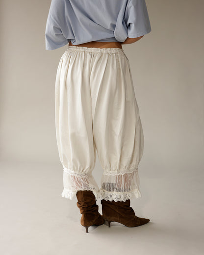 Ivory boho balloon pants with lace trim hem, paired with brown suede boots