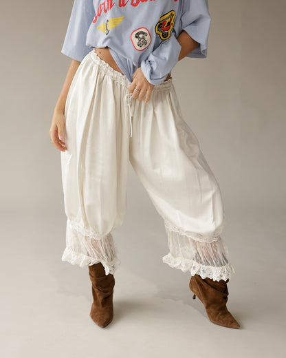 Cream satin balloon pants with lace trim hem and drawstring waist