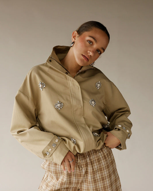 Women's khaki embellished bomber jacket with crystal brooches and plaid trousers