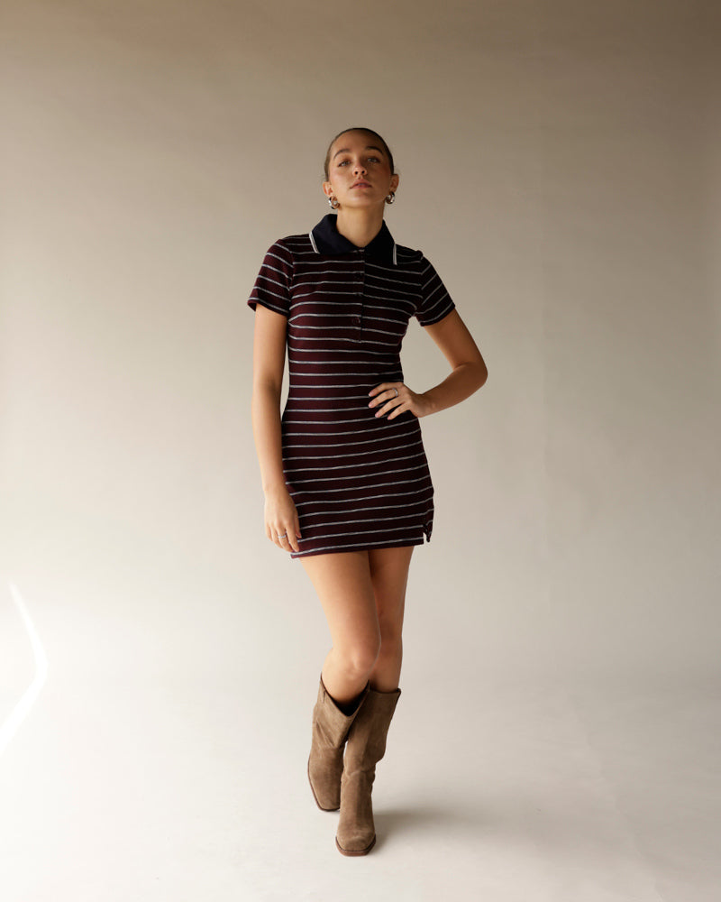 Burgundy striped polo mini dress with navy collar and short sleeves, styled with tan cowboy boots