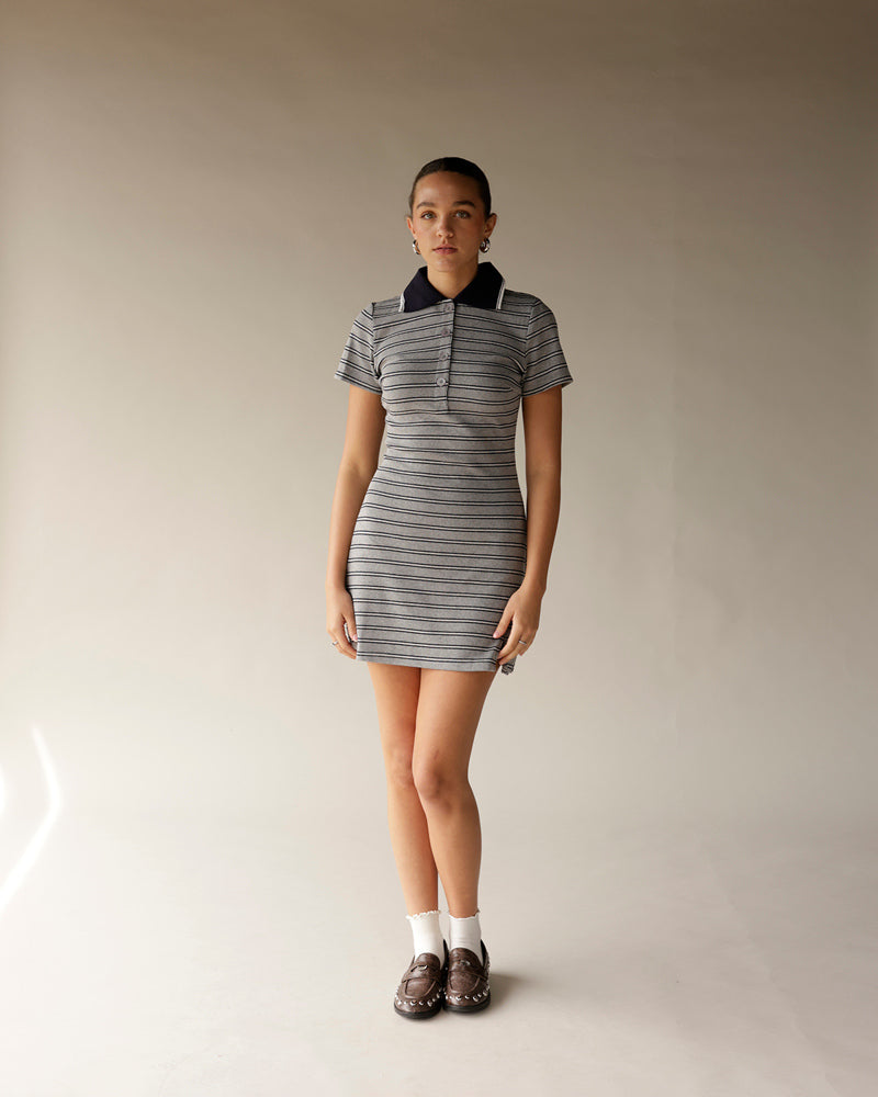 Gray striped polo mini dress with navy collar, short sleeves, and button placket